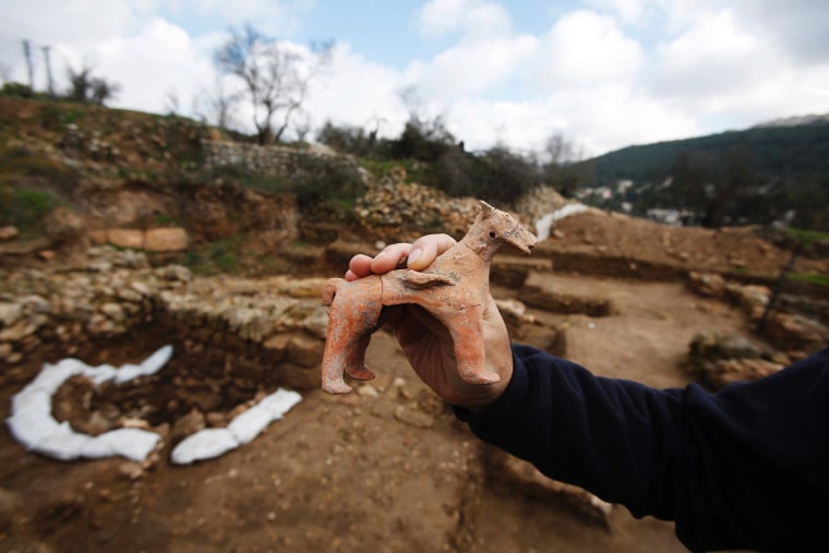 Archaeologist Anna Eirikh displays a horse figurine at Tel Motza archaeological site on the outskirts of Jerusalem.