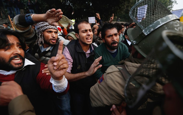 Policemen stop protesters from approaching a barricade on their way to India Gate while protesting against a recent gang-rape of a young woman in a moving bus in New Delhi on Dec. 27.