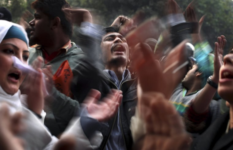 Indian protesters shout slogans while demonstrating against the recent gang rape of a young woman in a moving bus in New Delhi on Dec. 27.