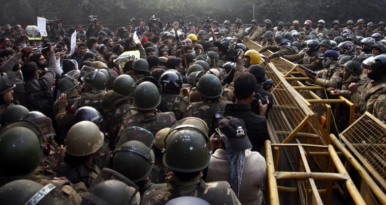 Indian security forces face students and activists shouting slogans, during a protest against the recent brutal gang-rape in New Delhi on Dec. 27.