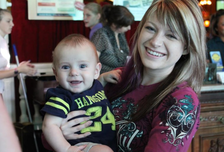 Jansen Young smiles while holding baby boy Jensen Larsen in Seattle. Young met Jensen's mom, Sheena Larsen, through Facebook after the shooting.