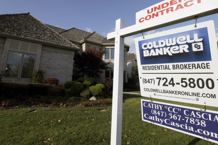 In this Wednesday, Oct. 10, 2012, photo, an under contract sign sits outside a home in Glen, Ill. Contracts to buy previously owned homes rose in Nove...