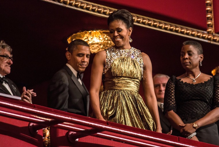 Michelle Obama glows in a gold Michael Kors gown at the Kennedy Center Honors Reception at the White House in Washington, DC, on Dec. 2.