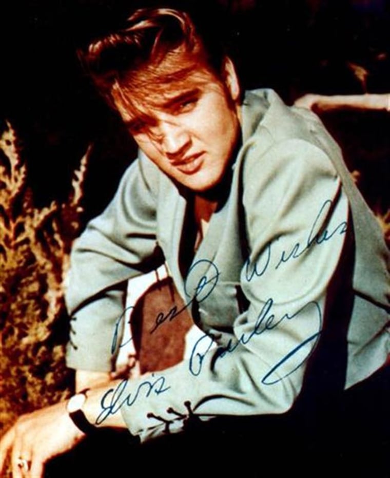 Singer Elvis Presley is pictured in an undated, autographed publicity photograph.