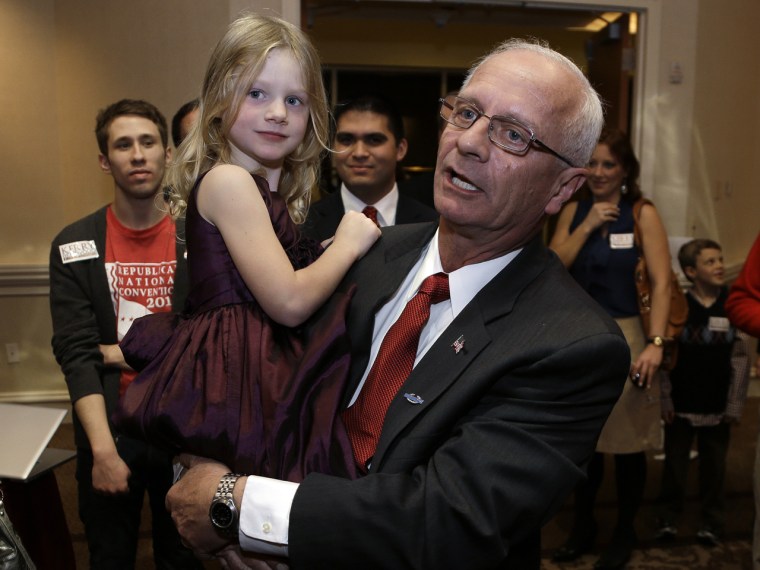 Republican Kerry Bentivolio, holding his granddaughter Emily Lee, 5, enjoys playing Santa at holiday parties and parades and often uses the reindeer he raises on his own ranch.