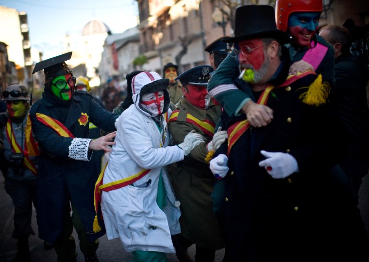 Revelers walk toward the battle of 'Enfarinats', a flour fight in celebration of the Els Enfarinats festival, on Dec. 28, in Ibi, Spain.