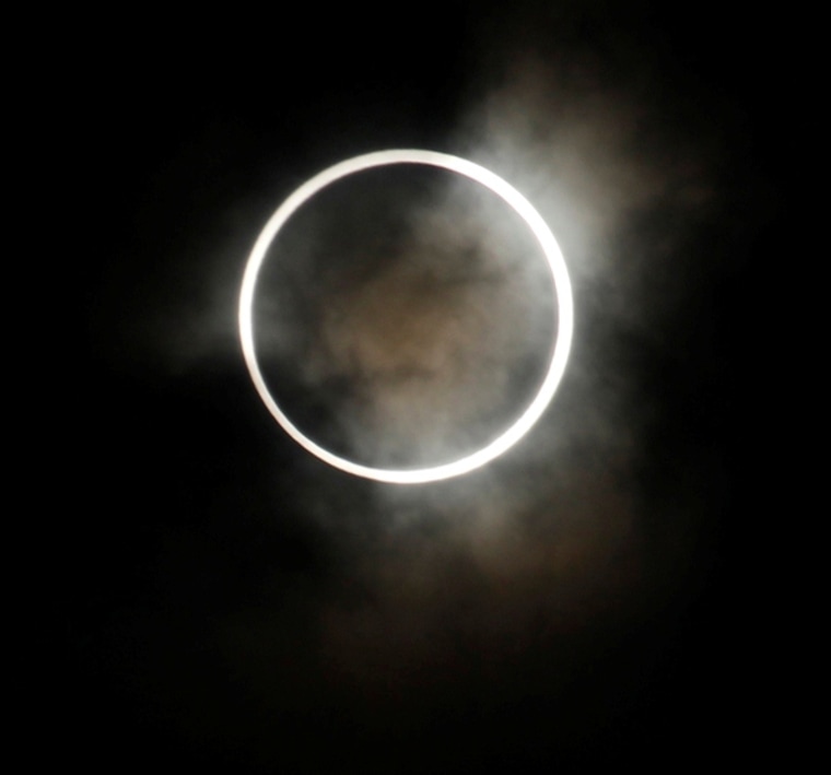 Clouds cast a pall over an annular solar eclipse as seen from Hirai Daini Elementary School in Tokyo on May 21, 2012. An annular eclipse is due to occur on May 10, 2013, and in November there'll be a hybrid eclipse that morphs from annularity to totality.