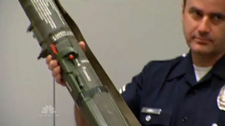 A Los Angeles police officer displays a rocket launcher turned in during a gun buyback effort on Thursday.