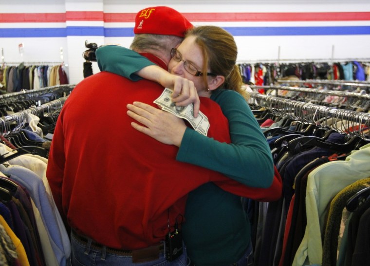 Janice Kennedy hugs Secret Santa after getting a $100 dollar bill from the wealthy philanthropist while looking for clothes at the Salvation Army store in Staten Island.