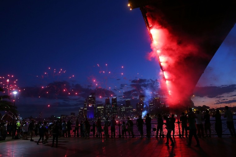 People watch fireworks under The Sydney Harbor Bridge during New Year's Eve celebrations on Dec. 31, 2012.