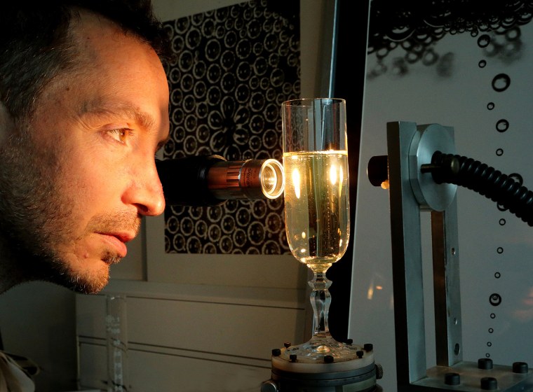 French researcher Gerard Liger-Belair works on a glass of champagne in his laboratory in Reims, located in the Champagne region in eastern France.