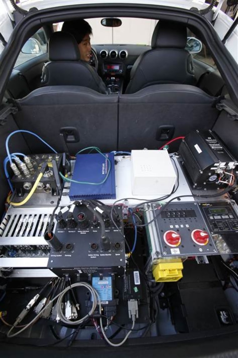 Stanford graduate student Mick Kritayakirana shows the computer system inside a driverless car on the Stanford University campus in Palo Alto, Calif.