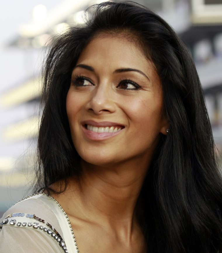 Nicole Scherzinger, girlfriend of McLaren Formula One driver Lewis Hamilton, looks into the grandstands before the start of the Abu Dhabi F1 Grand Prix at Yas Marina circuit in Abu Dhabi in this November 14, 2010 file photo. Former Pussycat Dolls singer Scherzinger will co-host the upcoming TV singing show