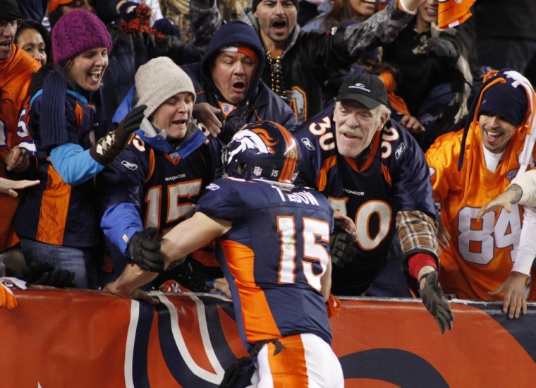 Denver Broncos quarterback Tim Tebow jumps into the crowd after throwing the winning touchdown against the Pittsburgh Steelers during overtime in their NFL AFC wildcard playoff football game in Denver, Colorado, January 8, 2012. REUTERS/Marc Piscotty (UNITED STATES  - Tags: SPORT FOOTBALL)