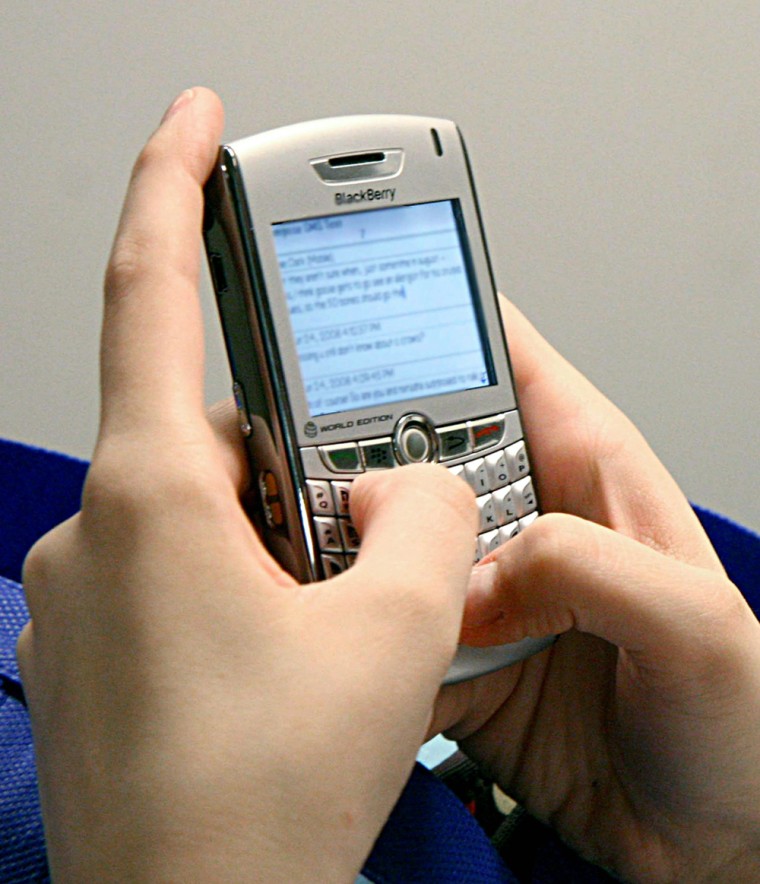 (FILES)A woman sends text messages on June 25, 2008 on her Blackberry phone while commuting on the Metro from Washington, DC to the Virginia suburbs. Smartphone security experts said August 3, 2010 that plans to ban BlackBerry data service in the United Arab Emirates are a testiment to how hard it is to snoop on that network and raise concerns about other devices becoming targets. AFP PHOTO/Karen BLEIER /FILES (Photo credit should read KAREN BLEIER/AFP/Getty Images)(Photo Credit should Read /AFP/Getty Images)