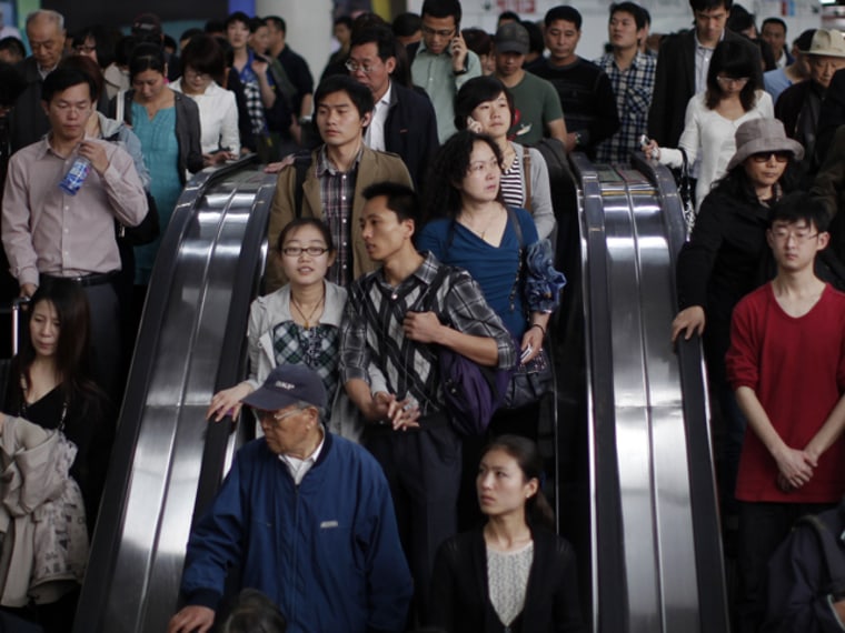 People enter a subway station in People's Square, Shanghai April 28, 2011. China's mainland population grew to 1.34 billion by 2010, according to census figures released on Thursday, up 5.9 percent from the 1.27 billion counted in the last census in 2000, and lower than the 1.4 billion population some demographers had projected for the latest tally. The Chinese government's strict controls on family size, including a one-child policy for most urban families, have brought down annual population growth to below one percent and the rate is projected to turn negative in coming decades. China's choke on family size to usually one child in cities and two in the countryside now threatens its economic future, many demographers have said, with fewer people left to pay and care for an increasingly graying population.REUTERS/Carlos Barria (CHINA - Tags: SOCIETY)