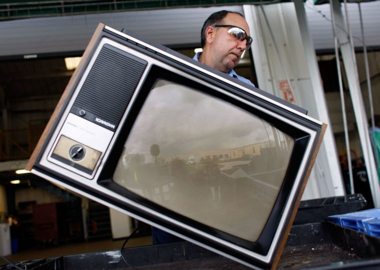 POMPANO BEACH, FL - JUNE 05: Jim Salem carries a discarded analog television set to a bin at the Broward County Waste & Recycling Services Solid Waste center on June 5, 2009 in Pompano Beach, Florida. As America switches to a digital signal on June 12th many are throwing out their old television sets. The switch to the digital television signal makes old analog televisions obsolete unless a converter box has been purchased. For the last 70 plus years people have watched television on analog. (Photo by Joe Raedle/Getty Images)