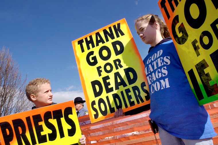 ** EDS: NOTE OFFENSIVE CONTENT ** FILE ** Westboro Baptist church member Gabriel Phelps-Roper, 10, and his sister Grace Phelps-Roper, 13, both of Topeka, Kan., protest at the funeral of Marine Lance Cpl. Matthew A. Snyder in Westminster, Md. in this March 10, 2006, file photo. The father of the fallen Marine has been awarded $2.9 million by a jury that found leaders of the fundamentalist Westboro Baptist church had invaded the family's privacy when they picketed the Marine's funeral. (AP Photo/Carroll County Times, Dylan Slagle) ** NO SALES **