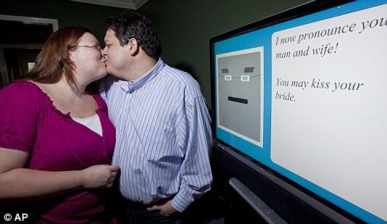 Miguel Hanson, right, kisses his fiancee Diana Wesley by the computer that will soon rule us all.