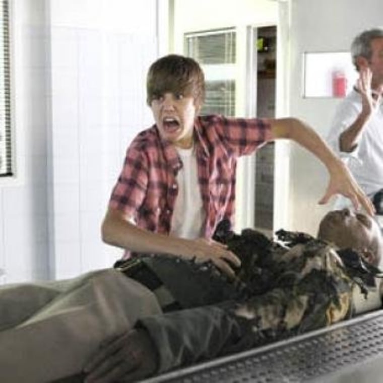 This photo of Justin Bieber fooling around on the set of CSI is potentially the best Facebook spam scam. Ever.