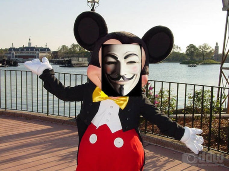 Anonymous added this photo to its Orlando website, featuring its mask over Mickey's face.