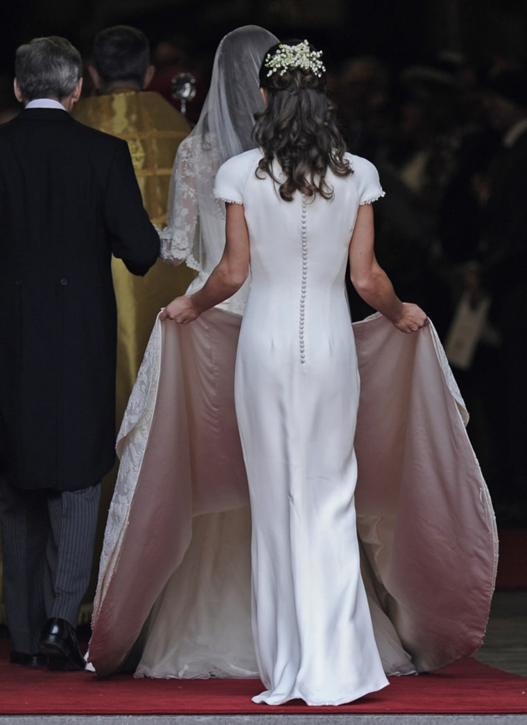 Pippa Middleton carries Kate Middleton's train as she arrives at Westminster Abbey with her father, Michael Middleton at the Royal Wedding with Britain's Prince William in London Friday, April, 29, 2011. (AP Photo/Martin Meissner)