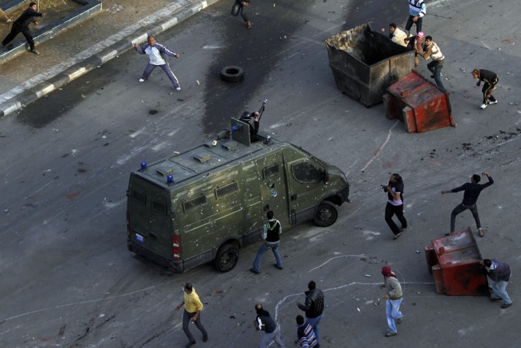 Egyptian anti-government protesters attack a riot police car at the port city in Suez, about 134 km (83 miles) east of Cairo east of Cairo, January 27, 2011. Police fired rubber bullets, water cannon and tear gas at hundreds of demonstrators in Suez on a third day of protests calling for an end to President Hosni Mubarak's 30-year-old rule. REUTERS/Mohamed Abd El-Ghany (EGYPT - Tags: CIVIL UNREST POLITICS CRIME LAW)