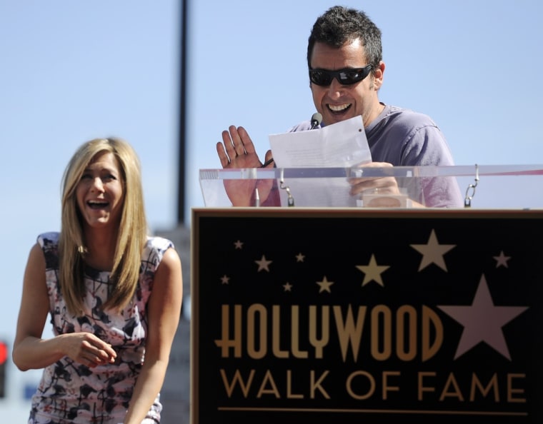 Actress Jennifer Aniston, left, reacts to a joke by actor-comedian Adam Sandler during a ceremony awarding Aniston a star on the Hollywood Walk of Fame in Los Angeles, Wednesday, Feb. 23, 2012. (AP Photo/Chris Pizzello)