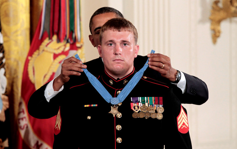 President Barack Obama awards the Medal of Honor to former Marine Corps Cpl. Dakota Meyers, 23, from Greensburg, Ky., Thursday, Sept. 15, 2011, during a ceremony in the East Room of the White House in Washington. Cpl. Meyers was in Afghanistan's Kunar province in Sept. 2009 when he repeatedly ran through enemy fire to recover the bodies of fellow American troops. He is the first living Marine to be awarded the Medal of Honor for actions in Iraq or Afghanistan. (AP Photo/Pablo Martinez Monsivais)