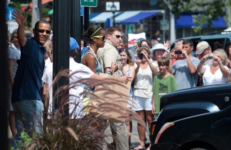 epa02872889 United States President Barack Obama waves to the crowd after visiting the Bunch of Grapes Book Store with his daughters during their vacation on Martha's Vineyard, in Vineyard Haven, Massachusetts, USA 19 August 2011. EPA/CJ GUNTHER