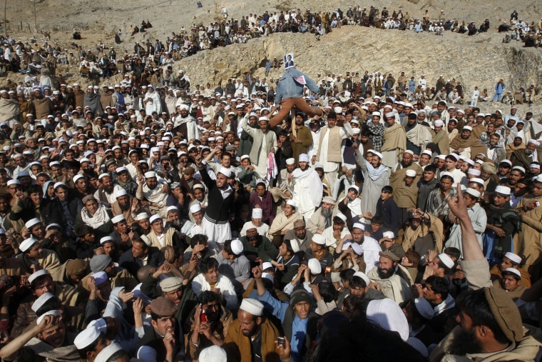Afghan men shout anti-U.S. slogans during a demonstration in Jalalabad province February 24, 2012. Twelve people were killed on Friday in the bloodiest day yet in protests that have raged across Afghanistan over the desecration of copies of the Muslim holy book at a NATO military base with riot police and soldiers on high alert braced for more violence. REUTERS/Parwiz (AFGHANISTAN - Tags: CIVIL UNREST RELIGION)