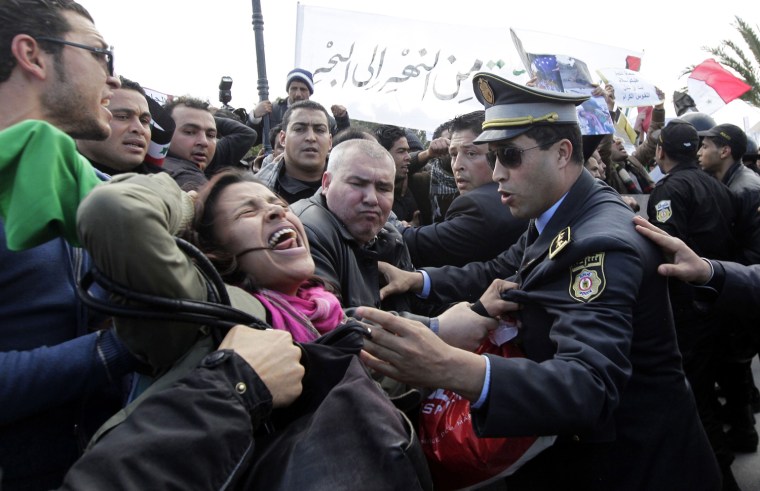 epa03119999 Supporters of Syrian President Bashar Al-Assad scuffle with Tunisian police near the venue where Friends of Syria conference is convening, in Tunis, Tunisia, 24 February 2012. Hundreds of supporters of al-Assad protested outside the planned Friends of Syria conference on 24 February, calling the participants 'enemies of Syria.' The crowd consisted largely of leftist Tunisians. The protesters were prevented by security guards from coming close to the building where the conference was to be held. EPA/MOHAMED MESSARA