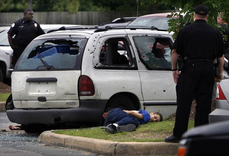 A suspect later identified  by Arkansas police as Joseph T. Kane lies dead as West Memphis, Arkansas Police investigate the scene of a shootout in the parking lot of the West Memphis WalMart, May 20, 2010, after Crittenden County Sheriff Deputies cornered suspects from a previous Police shooting on I-40. West Memphis Police Officers Brandon Paudert and Bill Evans were shot and killed after a shootout on Interstate 40 in West Memphis today. The suspect van was later cornered in a Walmart parking lot in West Memphis where a shootout occurred. Crittenden County sheriff Dick Busby was shot, as was his chief of patrol, W.A. Wren. As of 2 p.m., both were being rushed into surgery after being airlifted to the Regional Medical Center at Memphis. The bodies of the younger Kane and his father, Jerry R. Kane Jr., 45, of Forest, Ohio,  were pulled from a van at the Walmart.