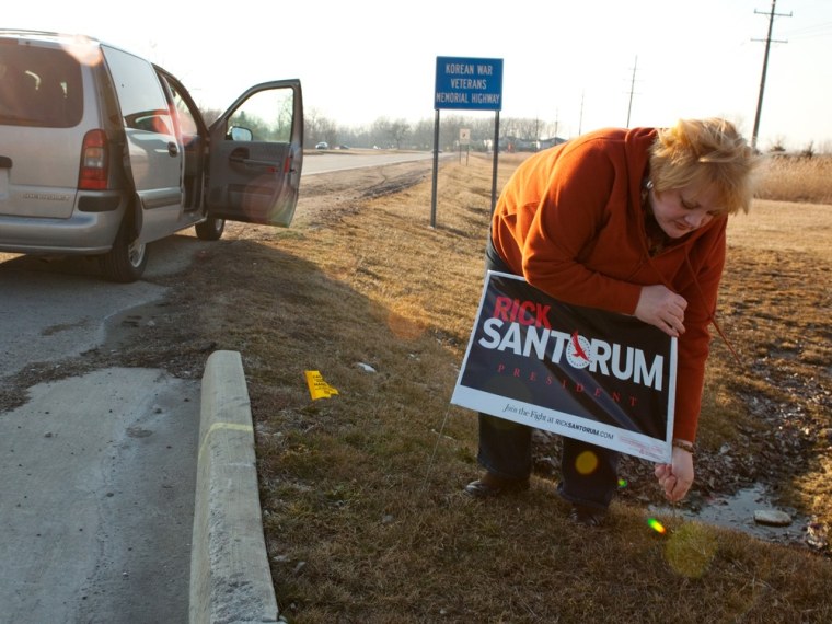 Sunday, February 26, 2012, in St. Clair Shores, MI (John Makely / msnbc.com) Penny Phelan places a Rick Santorum sign near a busy intersection in Macomb County near Detroit on Sunday afternoon two days before the primary. Penny and James Phelan placed several signs throughout the area.