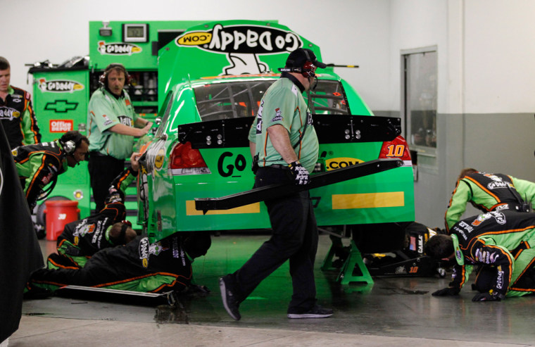 Crew members repair the car of driver Danica Patrick after a crash during the NASCAR Daytona 500 auto race at Daytona International Speedway in Daytona Beach, Fla., Monday, Feb. 27, 2012. (AP Photo/Terry Renna)
