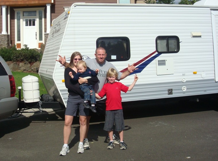 Suzi, Jason, baby Jacob and Ethan Jewett arrive home after a six-week trip in their trailer.