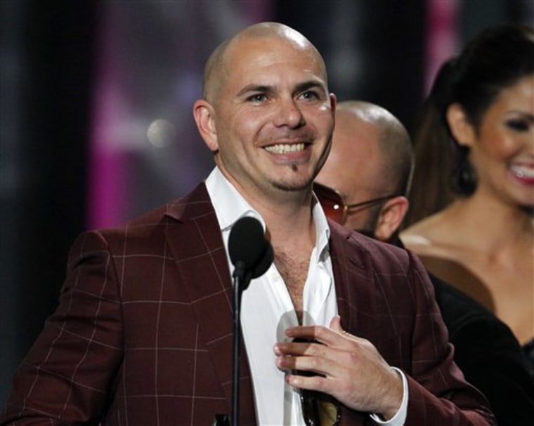 Pitbull smiles after accepting the award for the Song of the Year by a male performer during the Latin Billboard Awards in Coral Gables, Fla.
