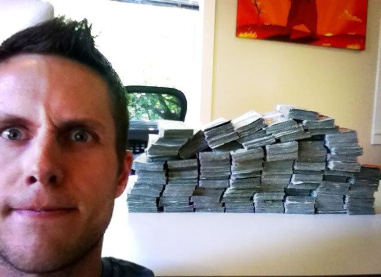 Matthew \"The Oatmeal\" Inman poses with the $211,223.04 he helped raise for charity.