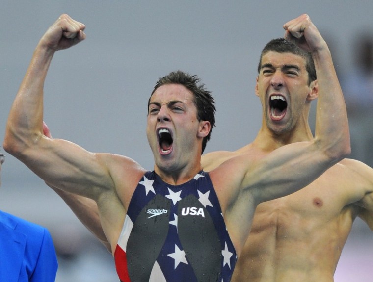 U.S. swimmer Garrett Weber-Gale (L), shown with Michael Phelps, demonstrates the universal and time honored signal for victory at the Beijing Olympic Games on August 11, 2008.