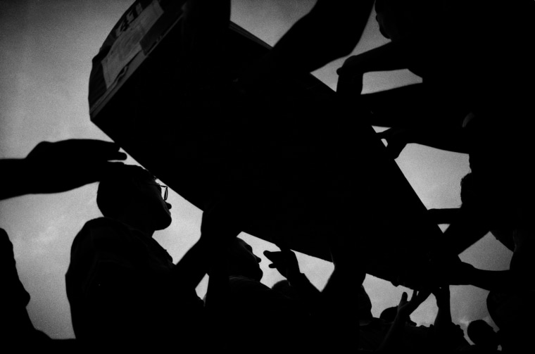 One of hundreds of coffins with remains of Bosnian Muslims is taken to a cemetery near Srebrenica, late July 10, 2007. The mass burial of 465 victims of the 1995 massacre of up to 8,000 Muslim men and boys by Bosnian Serb forces was held the following day at a joint cemetery near Srebrenica.