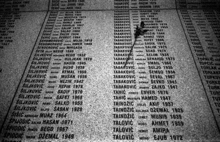 A flower is placed onto the names of the Srebrenica victims as relatives visit their memorial in Potocari, near Srebrenica on October 16, 2007.