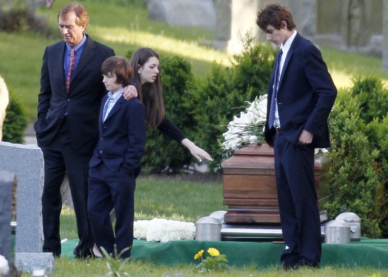 Robert F. Kennedy Jr., left, and his children turn away after paying their respects at the casket of Mary Richardson Kennedy, in St. Francis Xavier Cemetery in Centerville, Mass., Saturday, May 19, 2012.