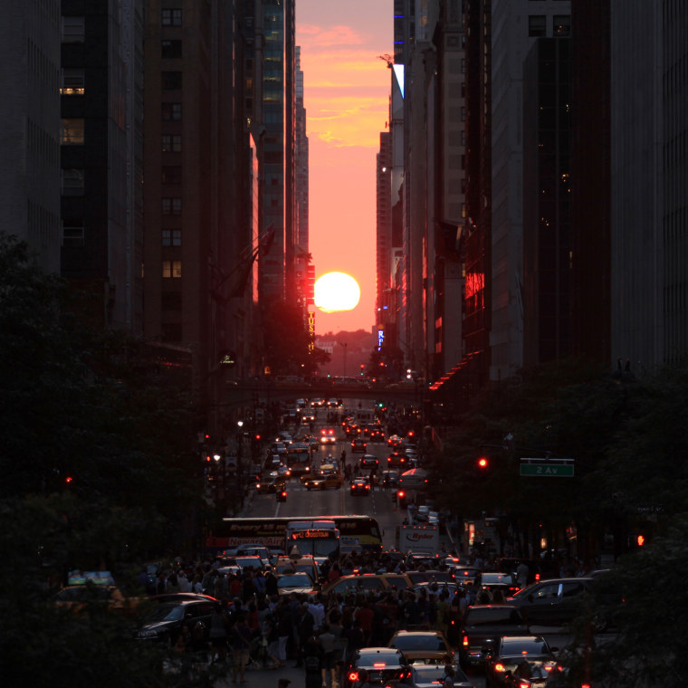 The sun sets over 42nd street, perfectly aligned with Manhattan's street grid during Manhattanhenge, on Wednesday, July 11, in New York, NY.