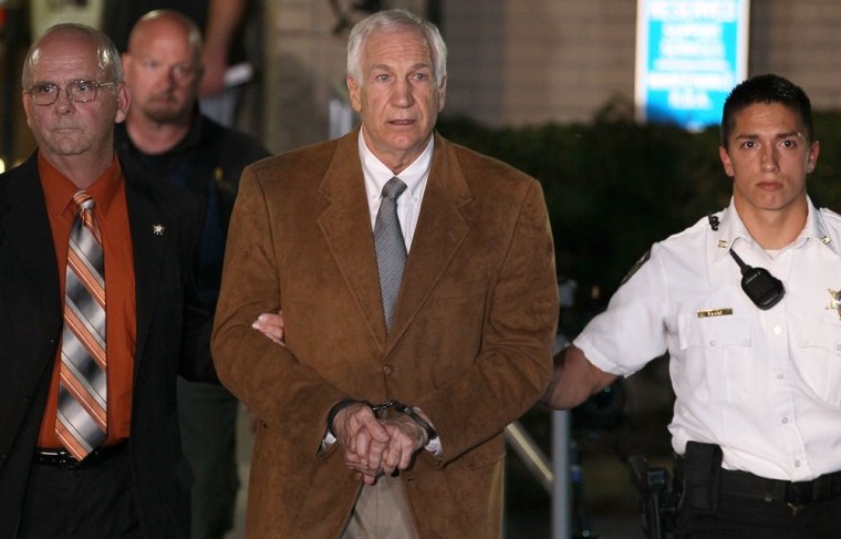 Former Penn State assistant football coach Jerry Sandusky leaves court in handcuffs after being convicted in his child sex abuse trial on June 22 in Bellefonte, Pa.