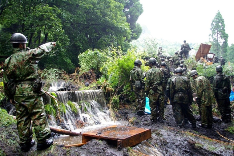 Self Defense Force personnel looking for dead bodies from a landslide in Aso city, Kumamoto prefecture, on July 13, 2012.