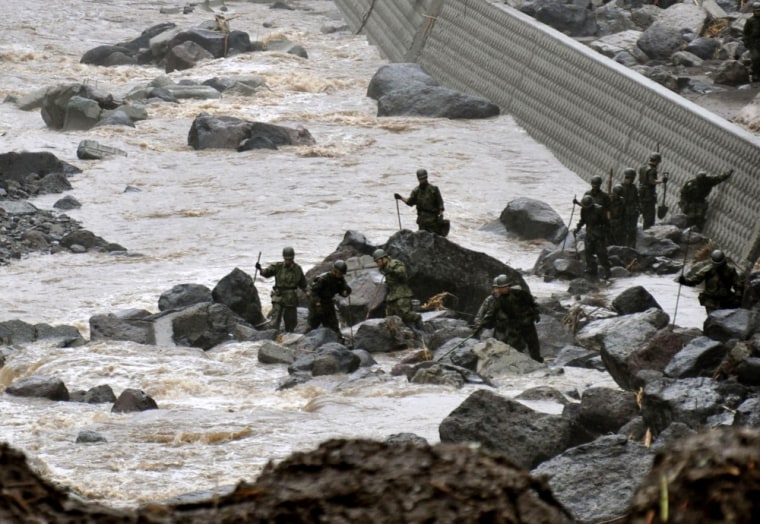 Members of Japan's Self Defense Force search for missing residents in Takeda, Oita Prefecture, on July 13, 2012. Heavy rains hit southern Japan on Thursday, triggering flashfloods, mudslides and destroying dozens of homes.
