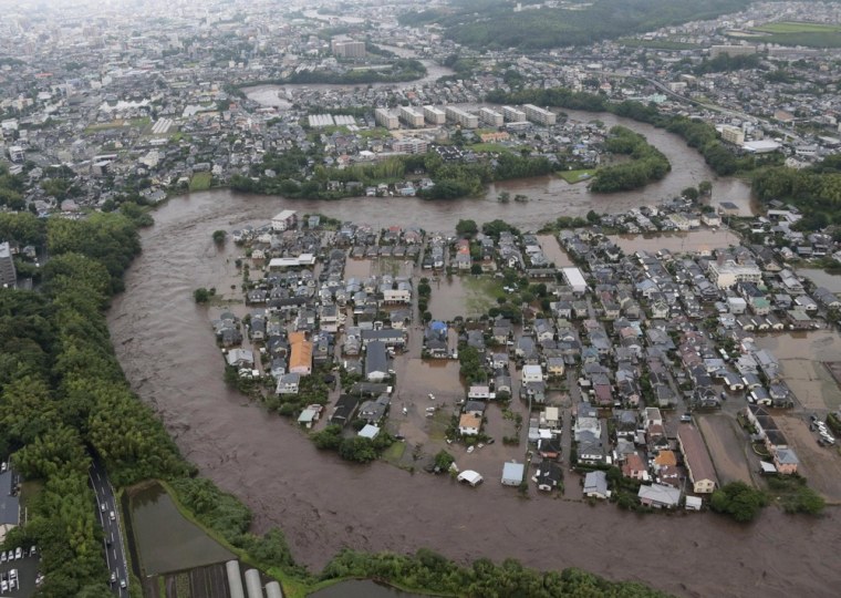 Residential streets are submerged after a river overflowed its banks in Kumamoto on the island of Kyushu on July 12, 2012.