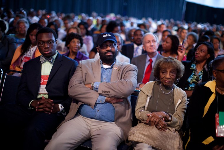 N. Scott Phillips, of Baltimore, Md., listens to Republican presidential candidate Mitt Romney deliver a speech during the NAACP annual convention Wednesday in Houston, Texas.