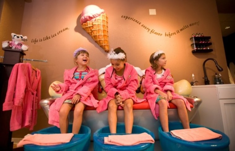 Kids don pink robes and tiaras at the ice cream-themed Scooops Spa at Great Wolf Lodge.