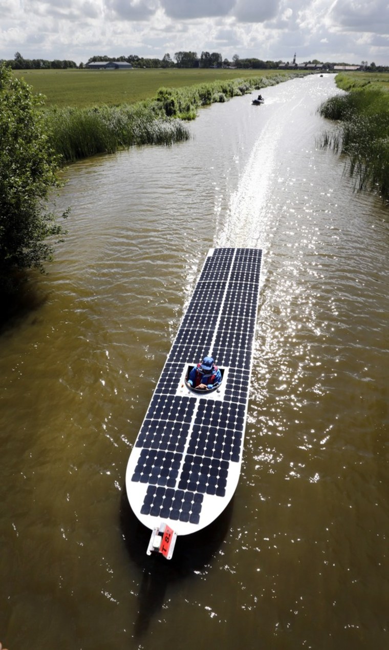 A solar boat from Maasdijk (Netherlands) sails from Arum to Harlingen during the Dong Energy Solar Challenge held in Leeuwarden, the Netherlands, on July 13. The solar boats have to pass a distance of 136 miles (220 kilometres) in six days.